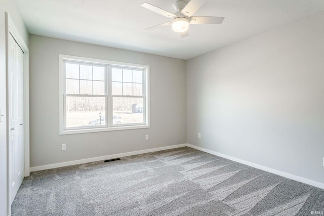 empty room featuring carpet and ceiling fan