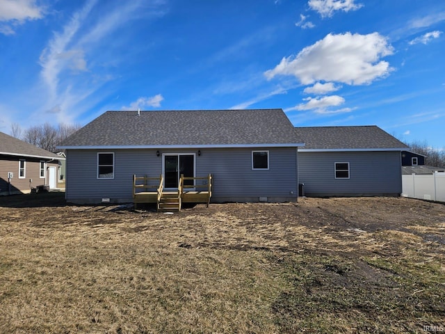 back of house featuring a yard and a deck