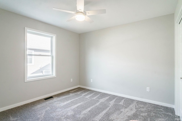 carpeted spare room with ceiling fan