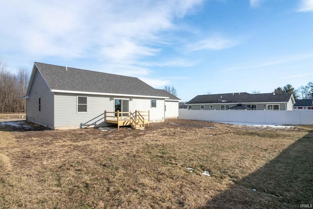 back of house with a lawn