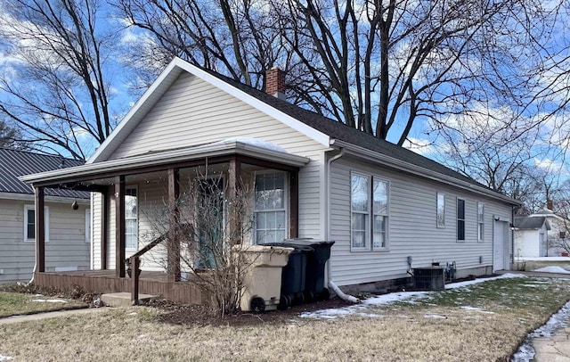 view of front of property with a garage and cooling unit