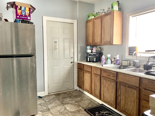 kitchen featuring sink and stainless steel refrigerator