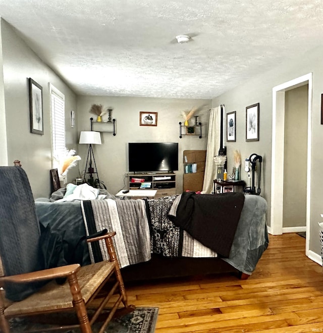 living room featuring hardwood / wood-style floors and a textured ceiling