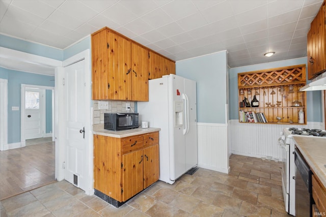 kitchen with tasteful backsplash and white appliances