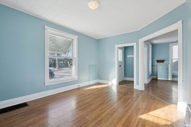 spare room with hardwood / wood-style floors