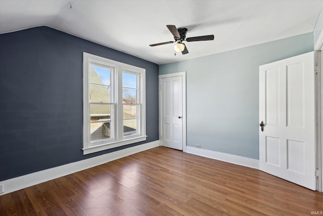 unfurnished bedroom featuring hardwood / wood-style flooring, ceiling fan, and vaulted ceiling