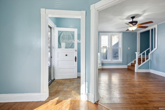 entryway with wood-type flooring and ceiling fan