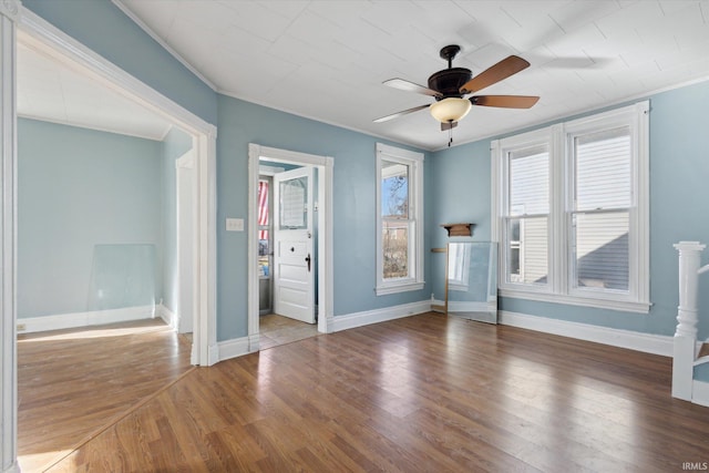 spare room featuring crown molding, wood-type flooring, and ceiling fan