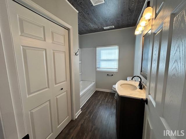 full bathroom with hardwood / wood-style floors, shower / bathtub combination, vanity, toilet, and wooden ceiling