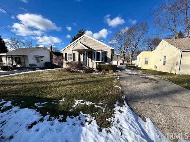 view of front of home with a lawn and covered porch