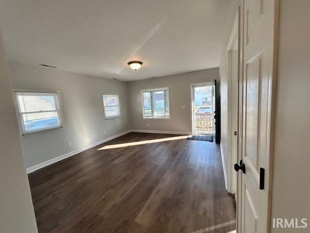 unfurnished room featuring dark hardwood / wood-style flooring