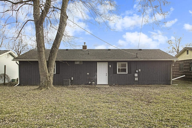 back of house featuring central AC unit and a yard