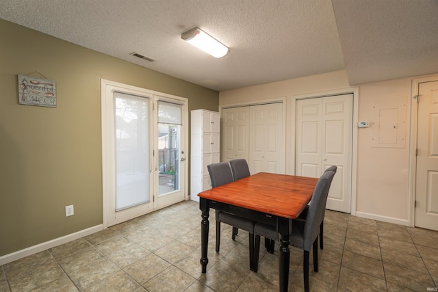 dining room with a textured ceiling