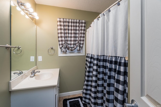 bathroom with vanity and a textured ceiling