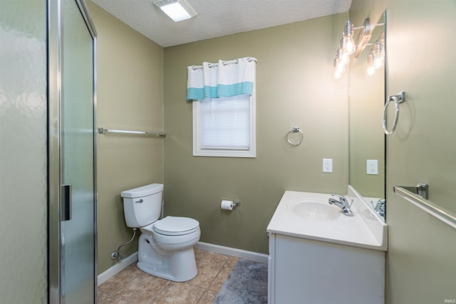 bathroom featuring tile patterned flooring, vanity, a textured ceiling, and toilet