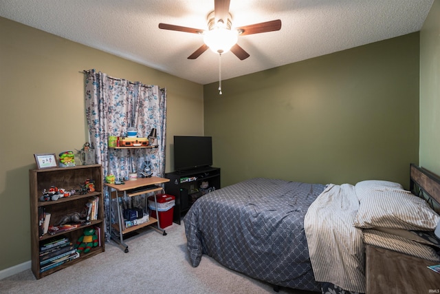 bedroom featuring ceiling fan, carpet floors, and a textured ceiling