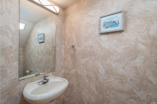 bathroom with sink and a textured ceiling