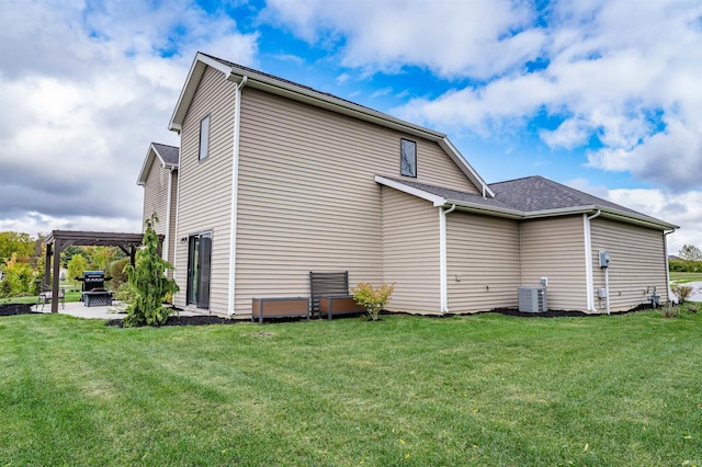 view of home's exterior featuring a lawn, a patio area, central air condition unit, and a pergola