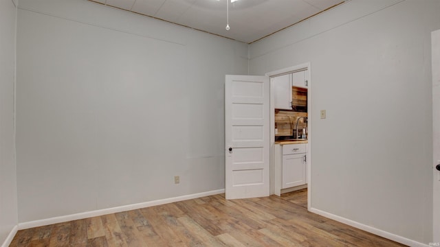 spare room with sink and light wood-type flooring