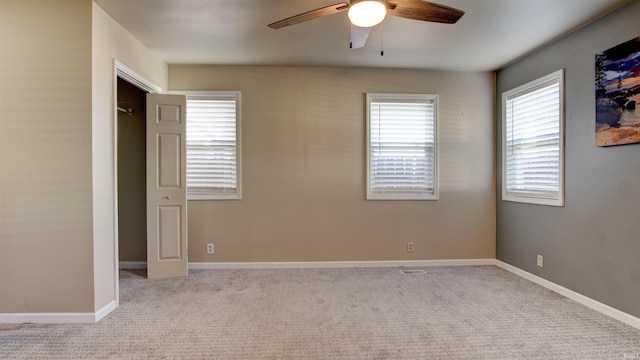 unfurnished bedroom featuring light colored carpet and ceiling fan