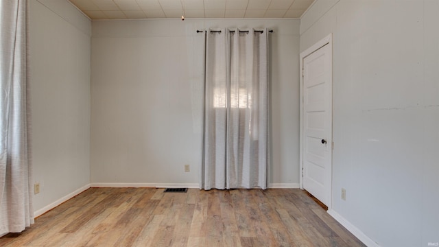 unfurnished room with light hardwood / wood-style flooring