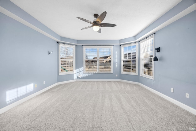 carpeted empty room featuring ceiling fan