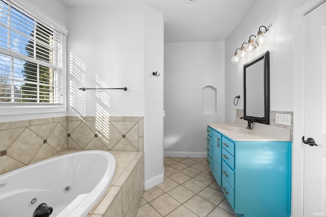 bathroom featuring vanity, tiled tub, and tile patterned floors