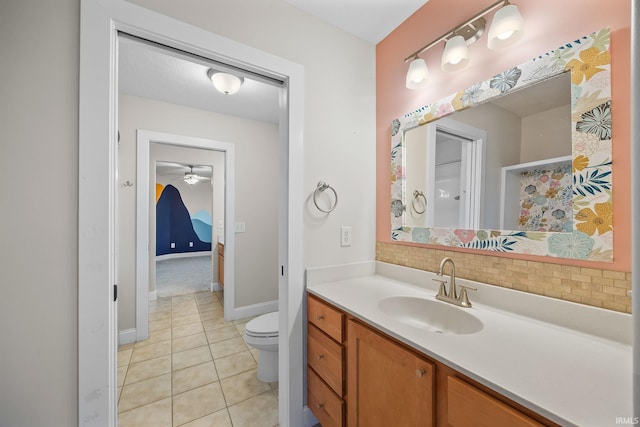 bathroom featuring tile patterned flooring, vanity, backsplash, and toilet