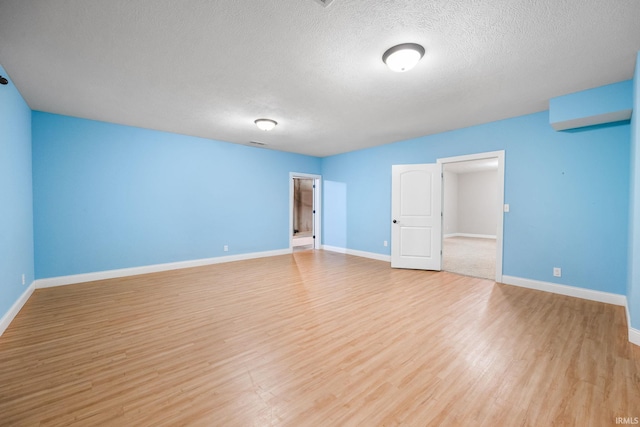 interior space featuring light hardwood / wood-style floors and a textured ceiling