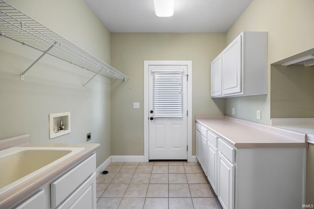 washroom with light tile patterned flooring, cabinets, hookup for a washing machine, and electric dryer hookup