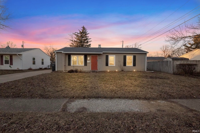 ranch-style home with a lawn