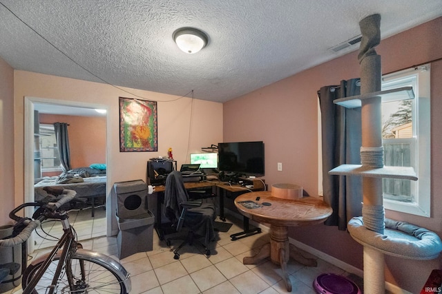 tiled office featuring a textured ceiling