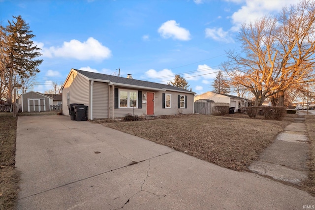 single story home featuring a storage unit