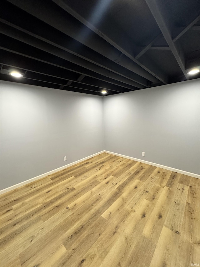 basement with light hardwood / wood-style floors