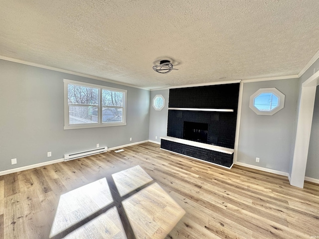 unfurnished living room featuring hardwood / wood-style flooring, a baseboard radiator, ornamental molding, and a textured ceiling