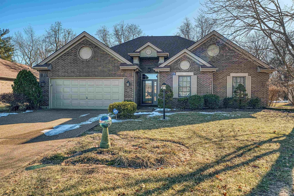 view of front of property with a garage and a front lawn