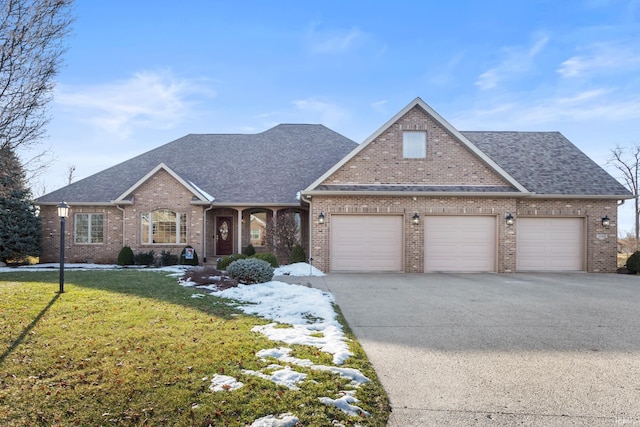 view of front of property with a garage and a front lawn