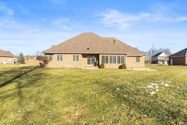 rear view of property with a lawn