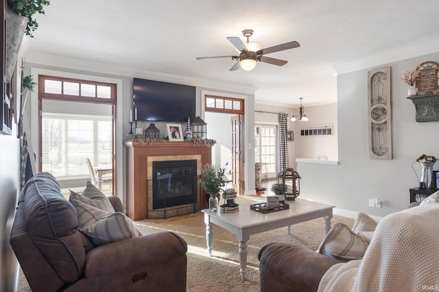 living room with crown molding, light colored carpet, ceiling fan, and a wealth of natural light