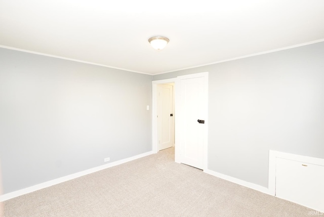 carpeted spare room with crown molding