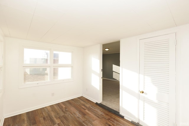 spare room featuring dark hardwood / wood-style flooring