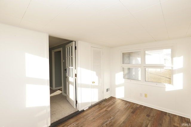 empty room with dark hardwood / wood-style floors