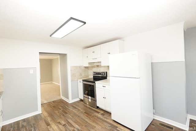 kitchen featuring hardwood / wood-style flooring, tasteful backsplash, white cabinets, stainless steel range with electric cooktop, and white fridge