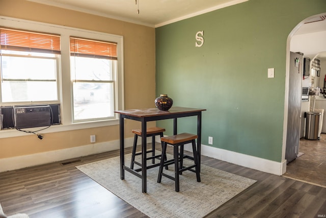 dining area featuring ornamental molding and dark hardwood / wood-style floors