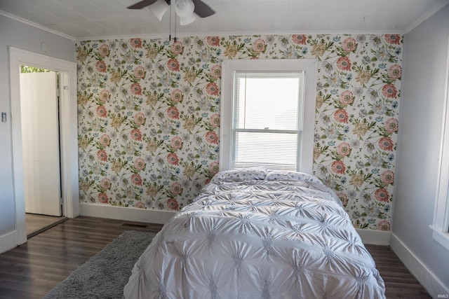 bedroom with crown molding, ceiling fan, and dark hardwood / wood-style flooring