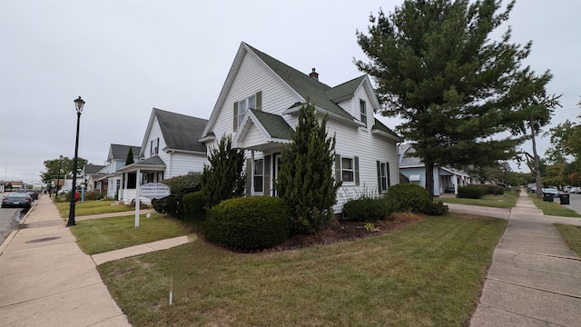 view of home's exterior with a yard