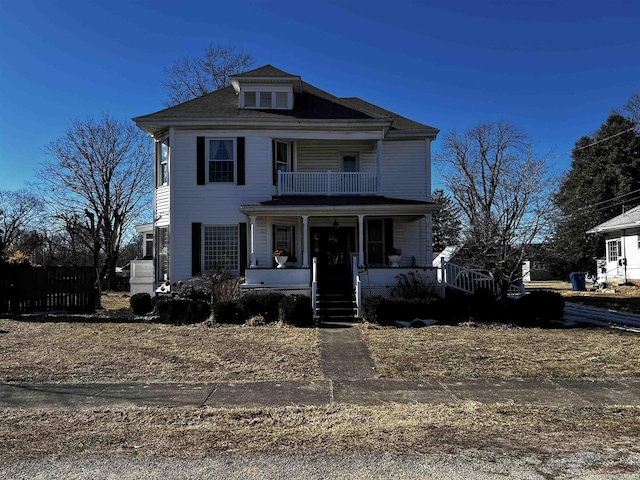 view of front of property featuring a porch and a balcony