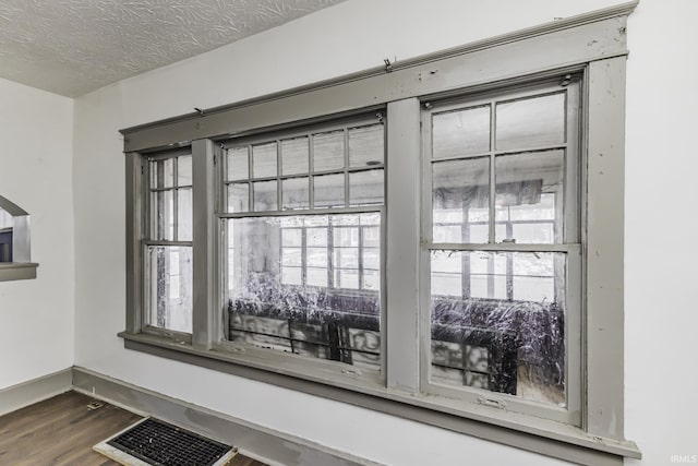 interior details featuring hardwood / wood-style floors and a textured ceiling