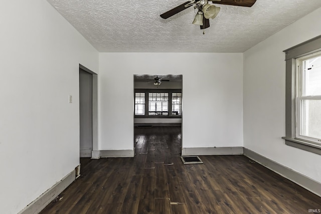 unfurnished room featuring ceiling fan, a textured ceiling, and dark hardwood / wood-style flooring