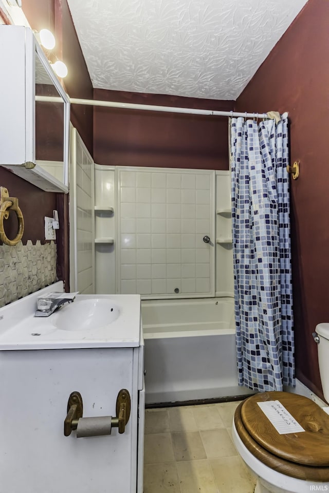 full bathroom featuring vanity, toilet, a textured ceiling, and shower / bath combo